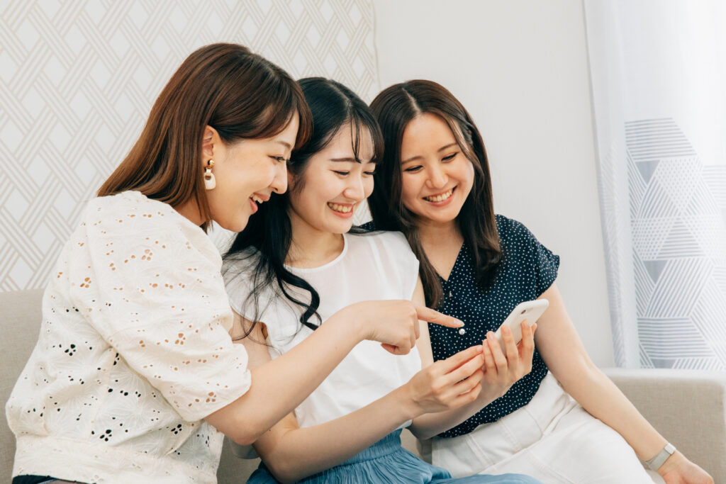 スマホを見る３人の女性